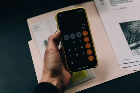 Smartphone calculator over household paperwork